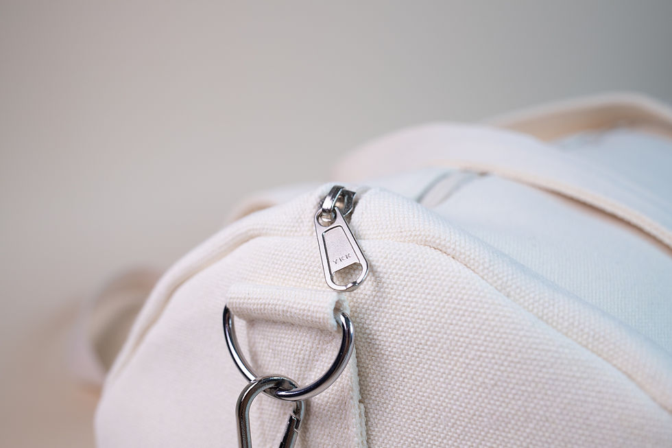 Close-up of premium zippers and metal hardware on a custom Merchpath duffle bag, showcasing refined details and durable stitching.
