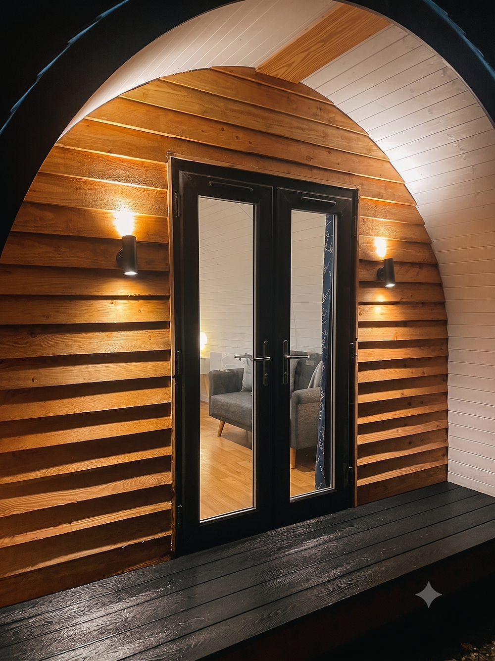 Entrance to a luxury glamping pod in Wales at night