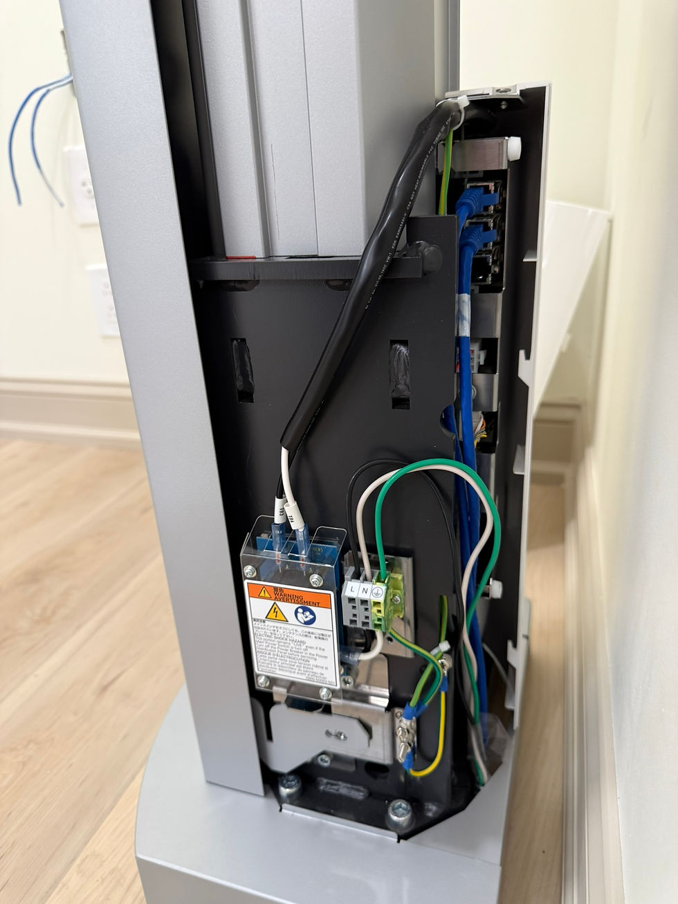 By running power and ethernet up through discrete holes behind the column, we created a cordless aesthetic for this client.