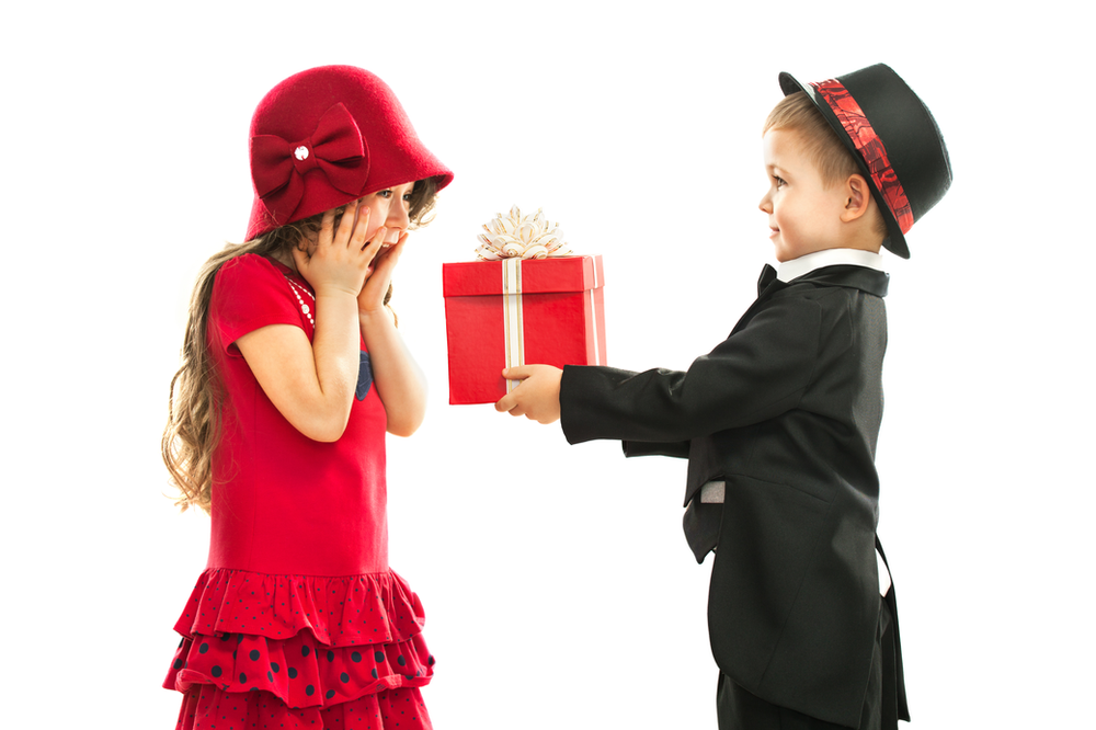 Little boy giving gift to little girl