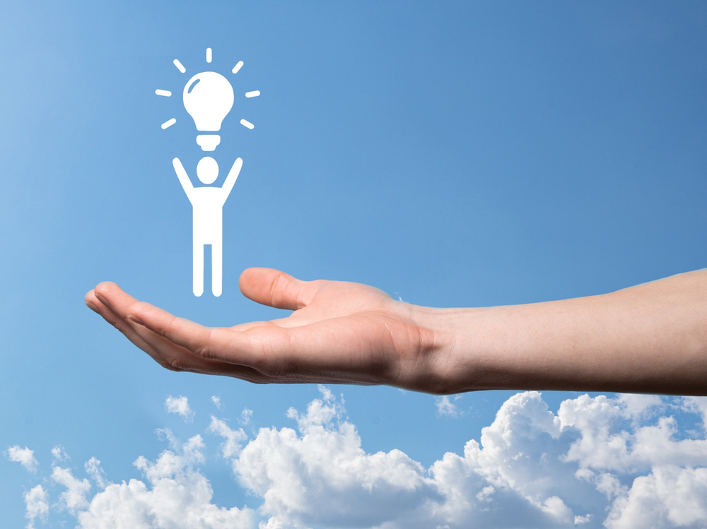 Human hand with human vector in his palm with lightbulb about it