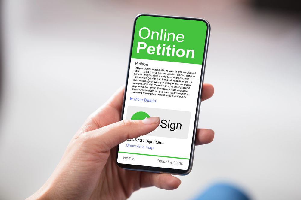 cell phone with an online petition page pulled up ready to be signed