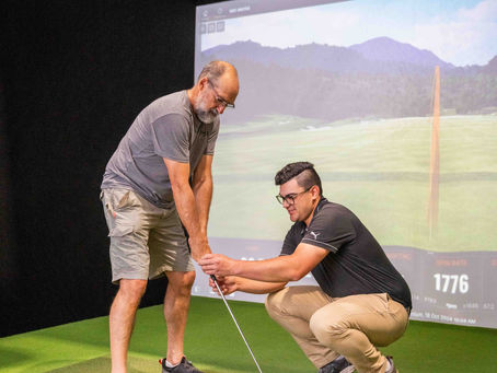 golf coach helping student