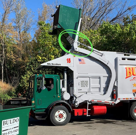 Buldo Brothers green and white garbage truck equipped with the Johnny Jaws rear-load to front-load conversion attachment