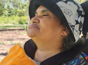 Toni with a big smile on her face looking at the beach