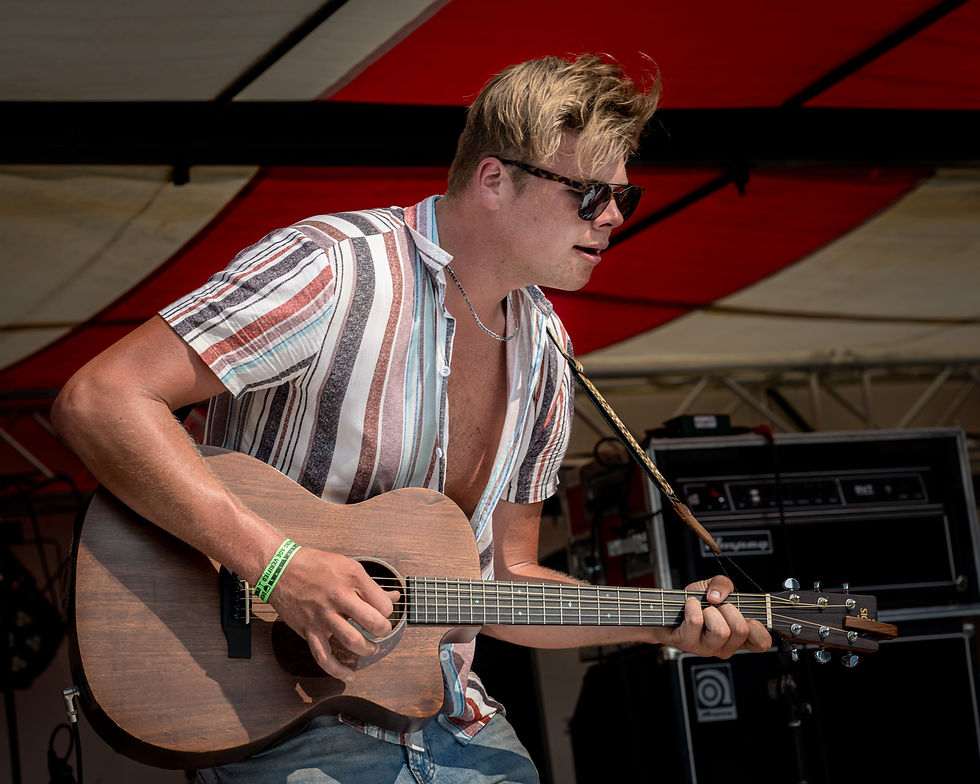 Brayden King playing guitar at Jeepfest
