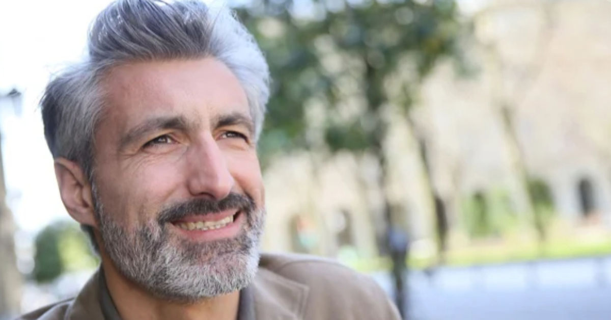 Mature man smiling outdoors - well-being lessons from 40 years of life experience