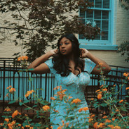 Model wandering through a field of marigolds