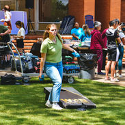 students playing corn hole outside