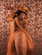 Model posed looking over her shoulder mid shot.