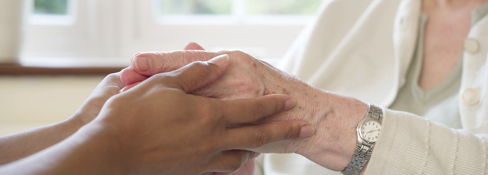Caregiver holding elderly hands