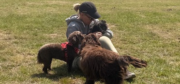Karen from Precious Pawz enjoying some quality time with the dogs in her care