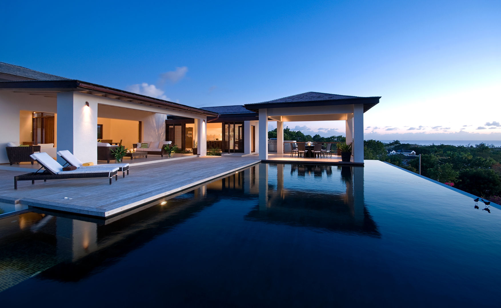 Sundeck
Barbados
Wide cinema-scope openings celebrate the panoramic West Coast views commanded by this family home.
Contemporary clean lines articulate the architectural language which blends Eastern and Western aesthetic traditions. Interior and exterior spaces are designed to flow together blurring boundaries and formalities.
The sheltered external living area is punctuated by islands of planting and bound by a dramatic black infinity edge pool.