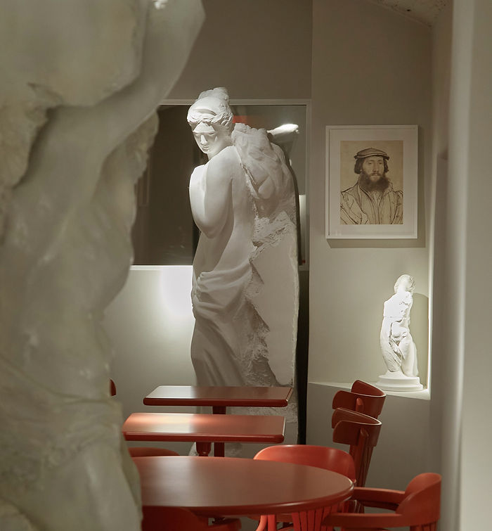 Hospitality interior design Sydney with plaster statues, red dining chairs and immersive restaurant atmosphere by AZAR