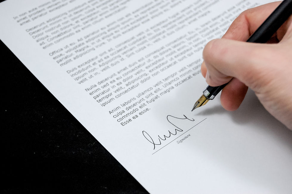 Close-up of hand with someone signing a contract