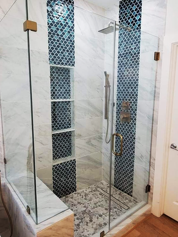 Elegant shower remodel with glass door, white marble and mosaic tiles BATHROOMS