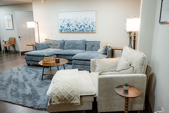 Modern therapy office lounge with blue and beige seating.