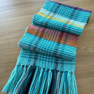 folded turquoise scarf on a wooden table