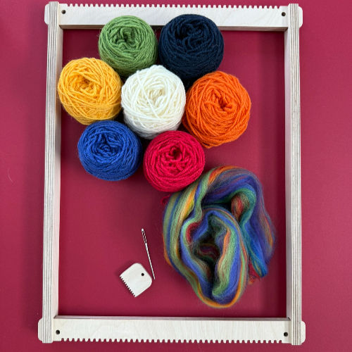 Colorful yarn balls on a red background with a wooden frame loom, a needle, and a white comb, creating a crafty, vibrant scene.
