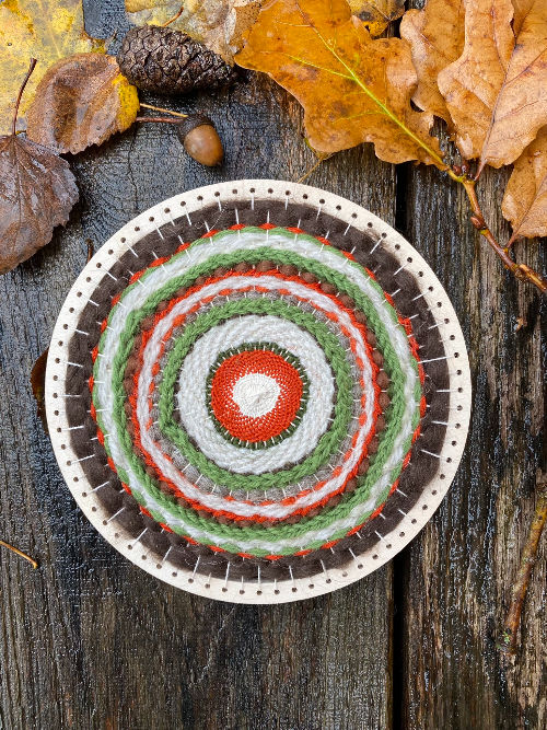 Thumbnail: circular weaving loomwoven with orange and brown colours of yarn