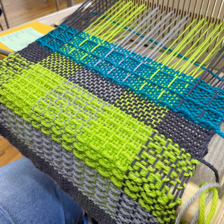 rigid heddle weaving in yellow, plum and turquoise