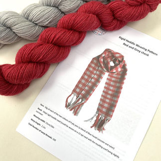 red and grey skeins of wool and instructions to weave a scarf