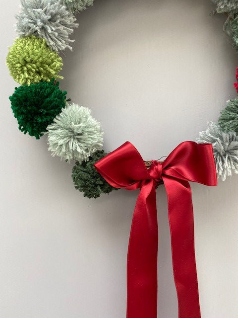 Thumbnail: red and green festive christmas pom pom wreath