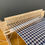 Thumbnail: rigid heddle weaving loom weaving a navy and grey houndstooth scarf