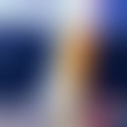 Snowy Machapuchhre (Fishtail) seen from Ulleri, with a blue-roofed house and forested hills under a clear sky.