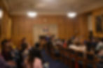 Rows of students around the debate-style setup in Parliament Hall. Presiden of the society standing at the front of the room