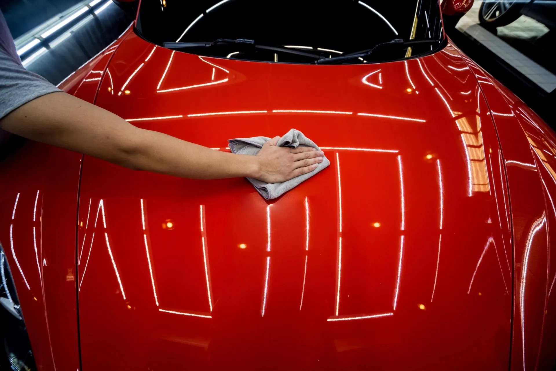 Thorpe Auto detailig staff doing ceramic coating on a red car