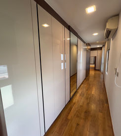 BHL Integrated hallway carpentry with flush wood cabinets and concealed storage design at 95 Duchess Road Singapore.