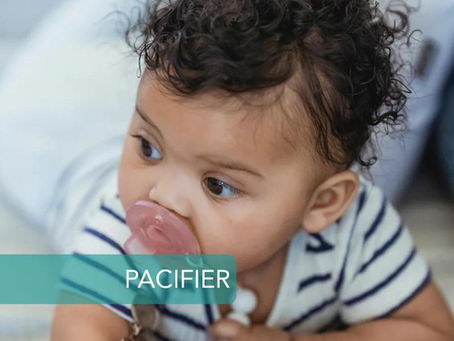 baby crawling with pacifier