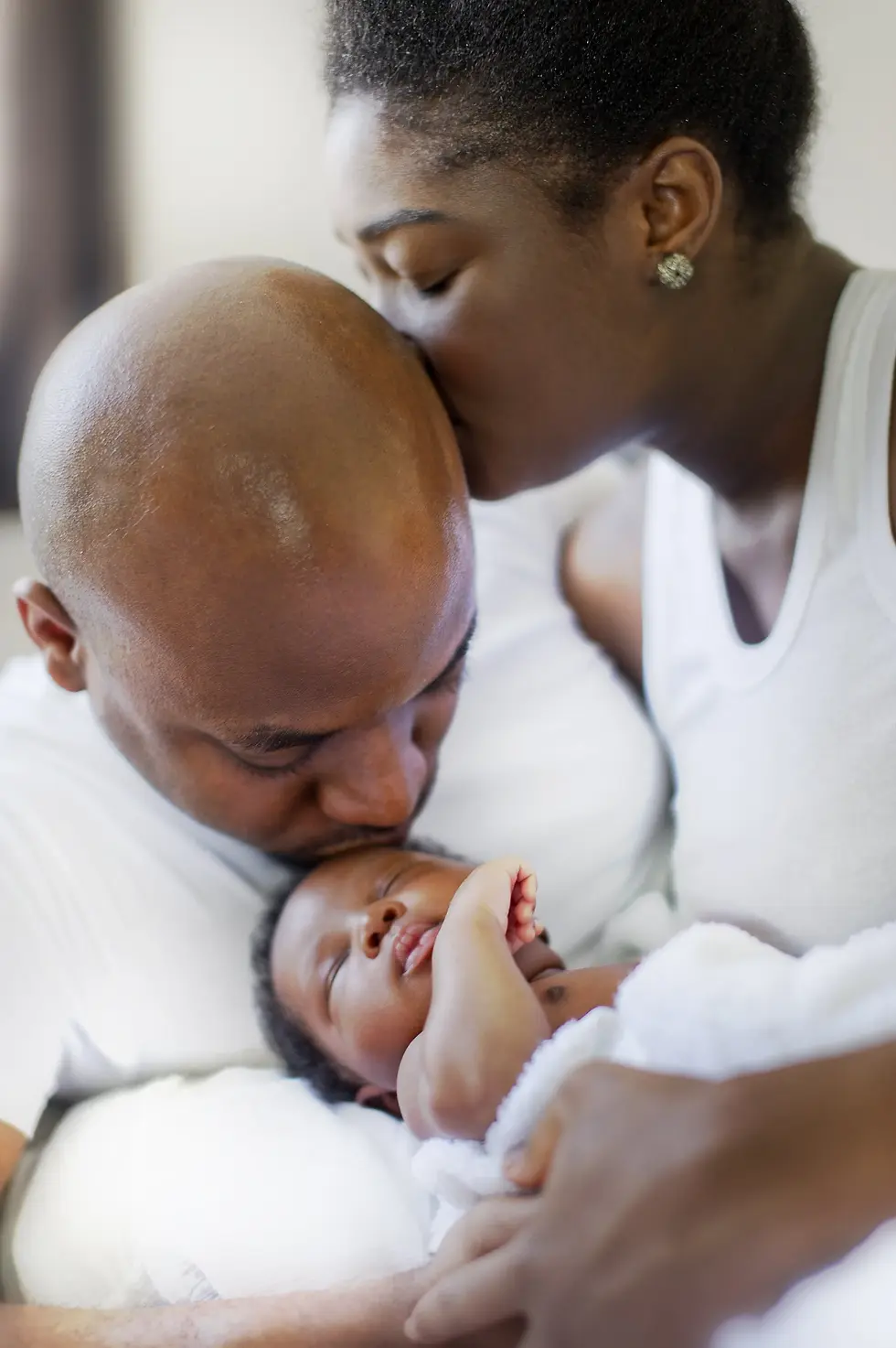 mom kisses dad, dad kisses child