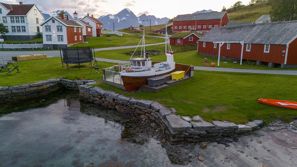 The grill boat at Havnnes with the playground and a trampoline in the backround, open for our guests to cook their meals and eat outside.