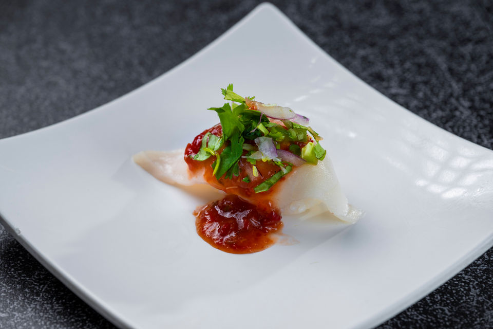 Delicious sushi with spicy sauce, cilantro, and red onion