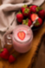 high-angle-strawberry-milkshake-with-straw-cloth
