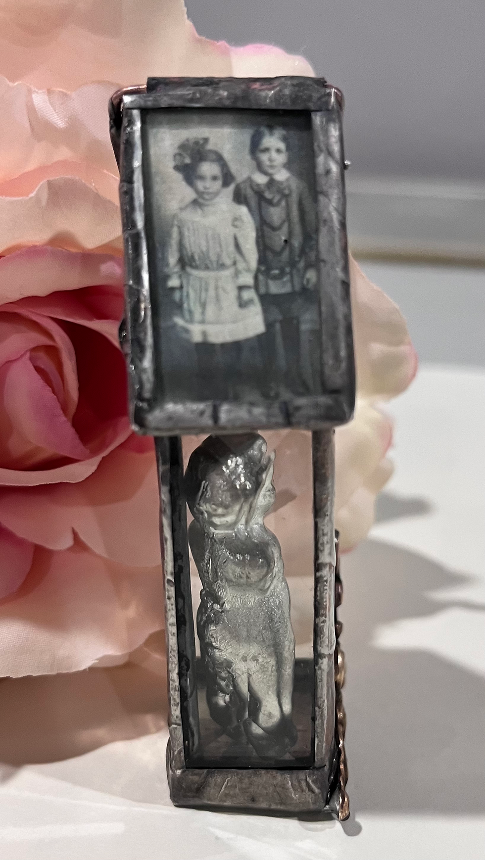 Thumbnail: Vintage locket with miniature photo of two children, figurine, pink rose.