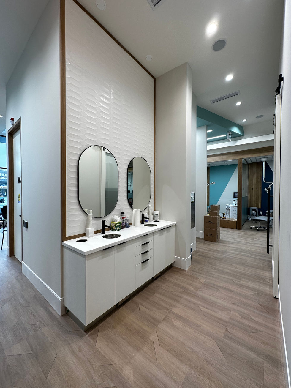a renovated dental office with two sinks and two mirrors