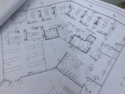 Close-up view of a construction blueprint with a pencil