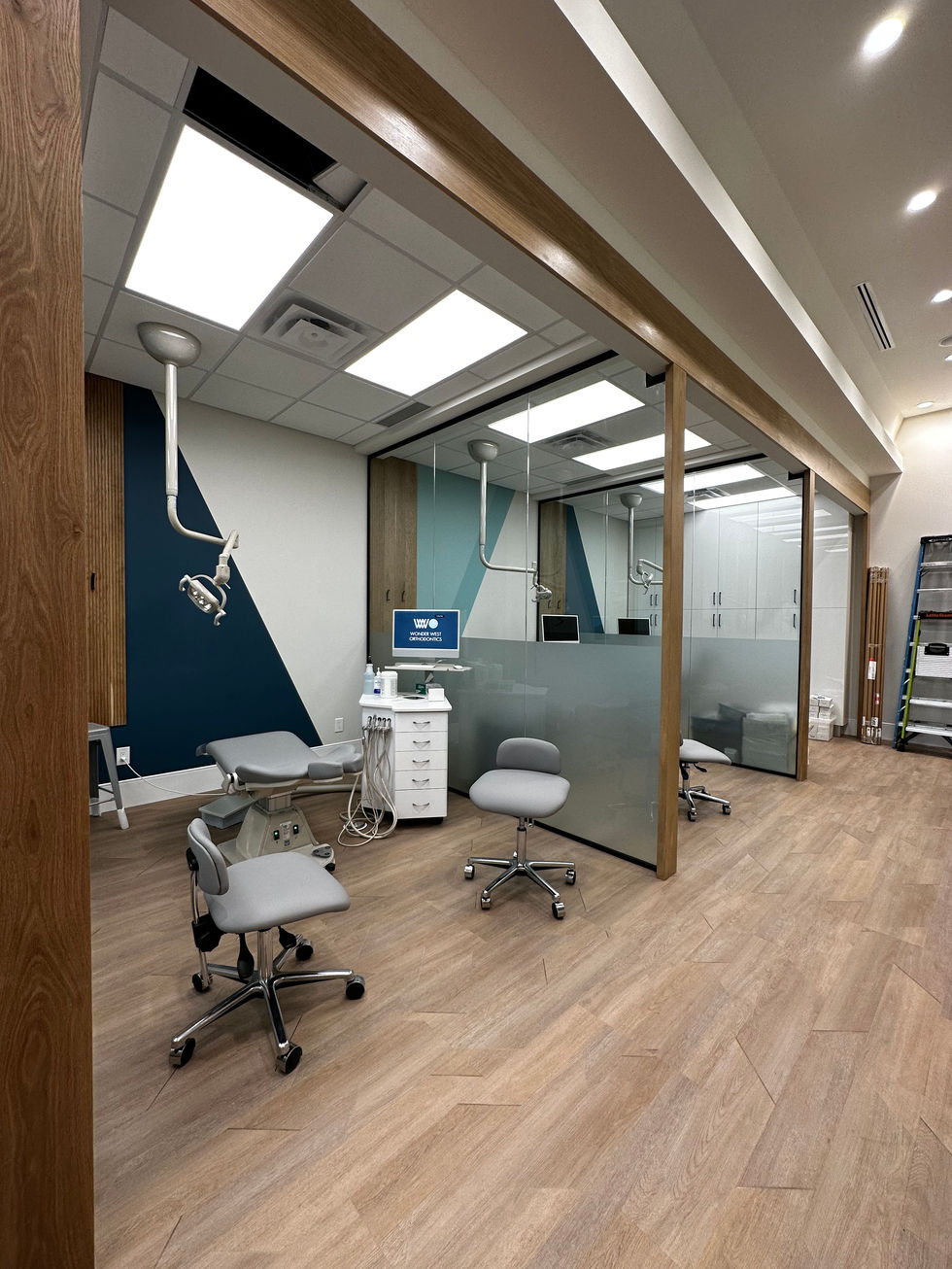 a dental office with a computer and chairs