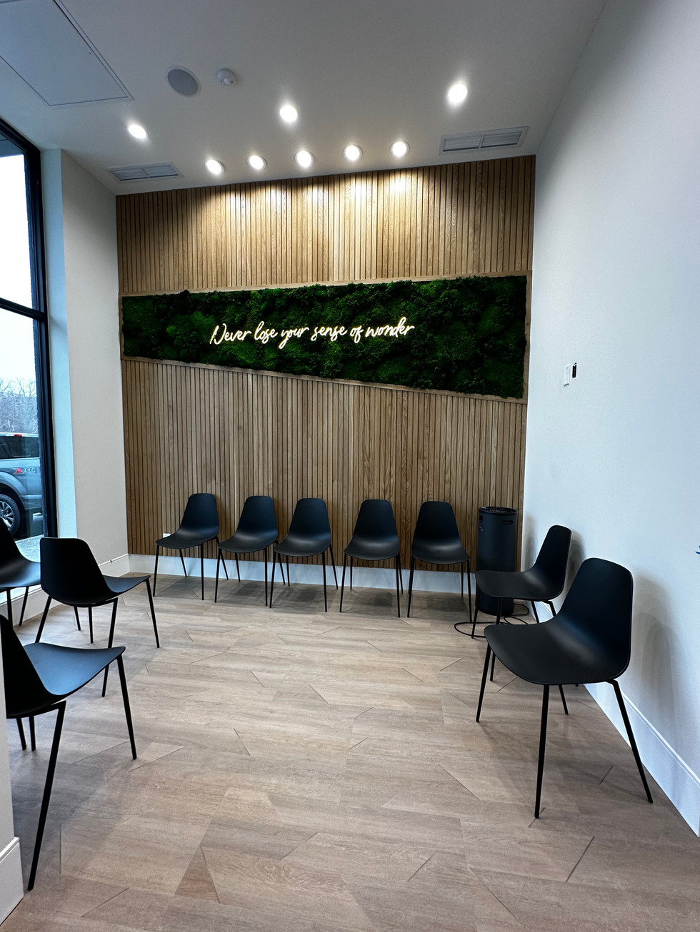 a waiting room with chairs and a sign that says " never lose your sense of wonder "