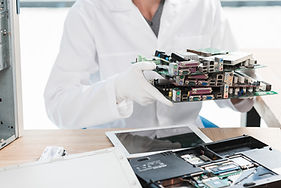 technician-holding-computer-parts-workshop.jpg