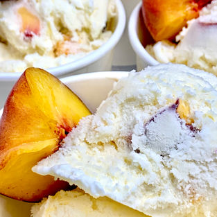 Scoops of small-batch vanilla bean ice cream swirled with spiced roasted South Carolina peach ribbons - Alexandra's Bakery