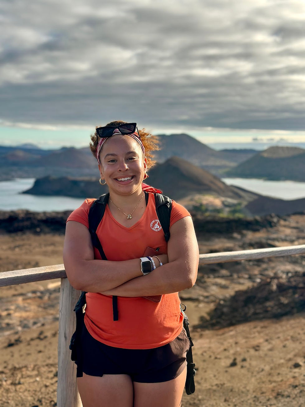 an image of Avril Silva atop a mountain in the Galapagos Islands archiapelago
