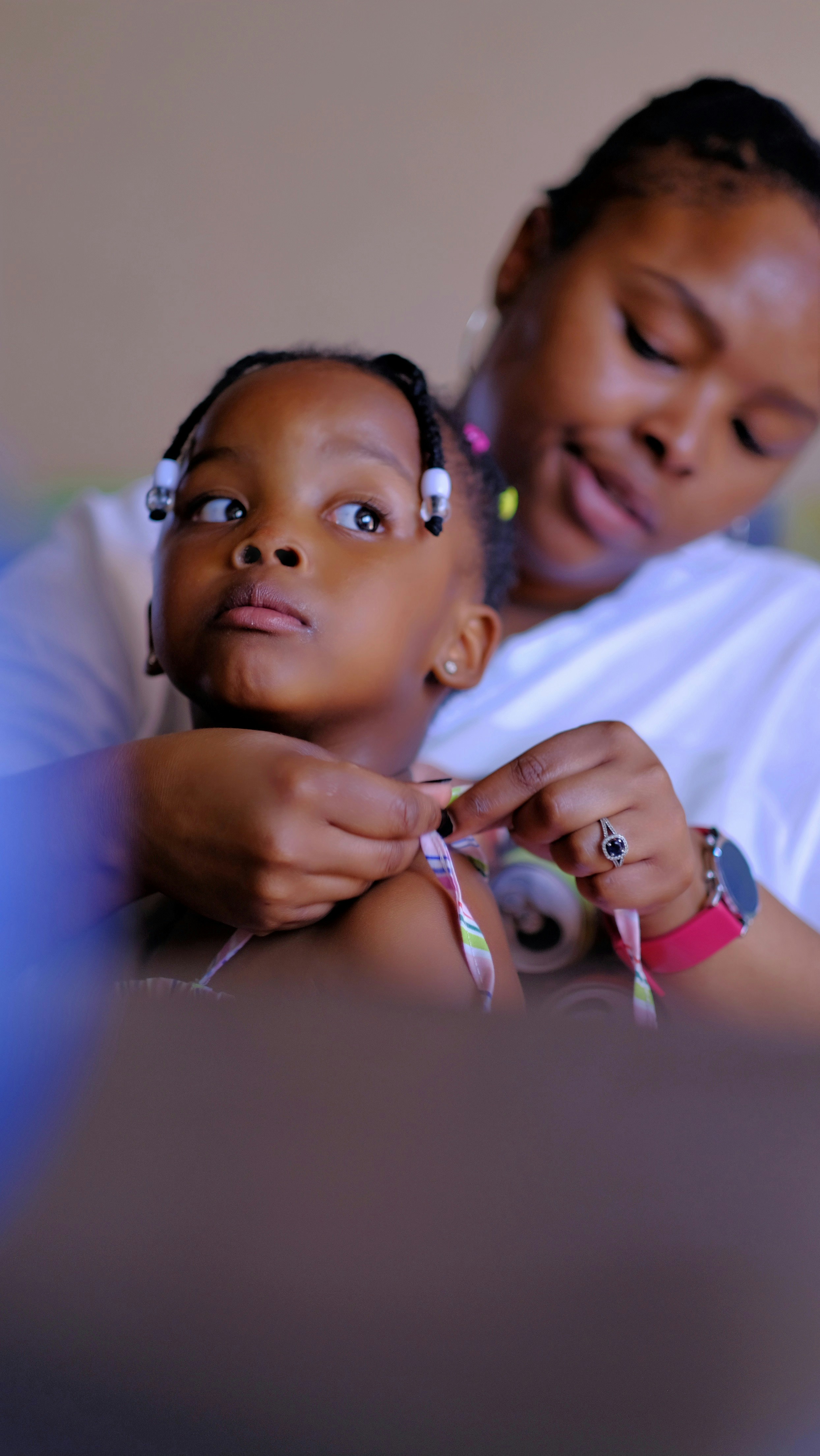 Child with diabetes checking blood sugar with a parent