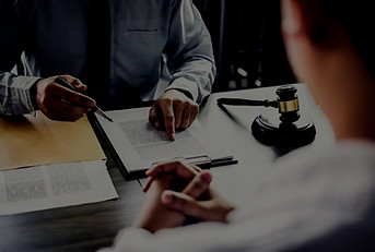 Two people reviewing paperwork at a desk