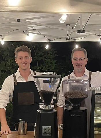 Baristas behind coffee cart