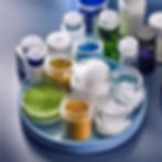 Various pharmaceutical ingredients in jars and bottles, representing the types of bulk raw materials such as active pharmaceutical ingredients (APIs), excipients, and intermediates that the pharmaceutical industry uses bulk bags for. These bulk bags, produced by Six Star Bulk Bag, provide a secure and contamination-free solution, ensuring the integrity and safety of pharmaceutical products during transit and storage. This method streamlines handling processes, maintains quality standards, and supports the stringent regulatory requirements of the pharmaceutical industry.