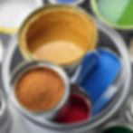 A variety of raw materials used in the paints, coatings, and color additives industries, including pigments, resins, dyes, and additives, are displayed in open containers. These materials are typically packaged and transported in bulk bags to ensure protection from contamination and moisture during transit and storage.